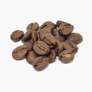 A small pile of coffee beans brown in colour from roasting, on a white background.